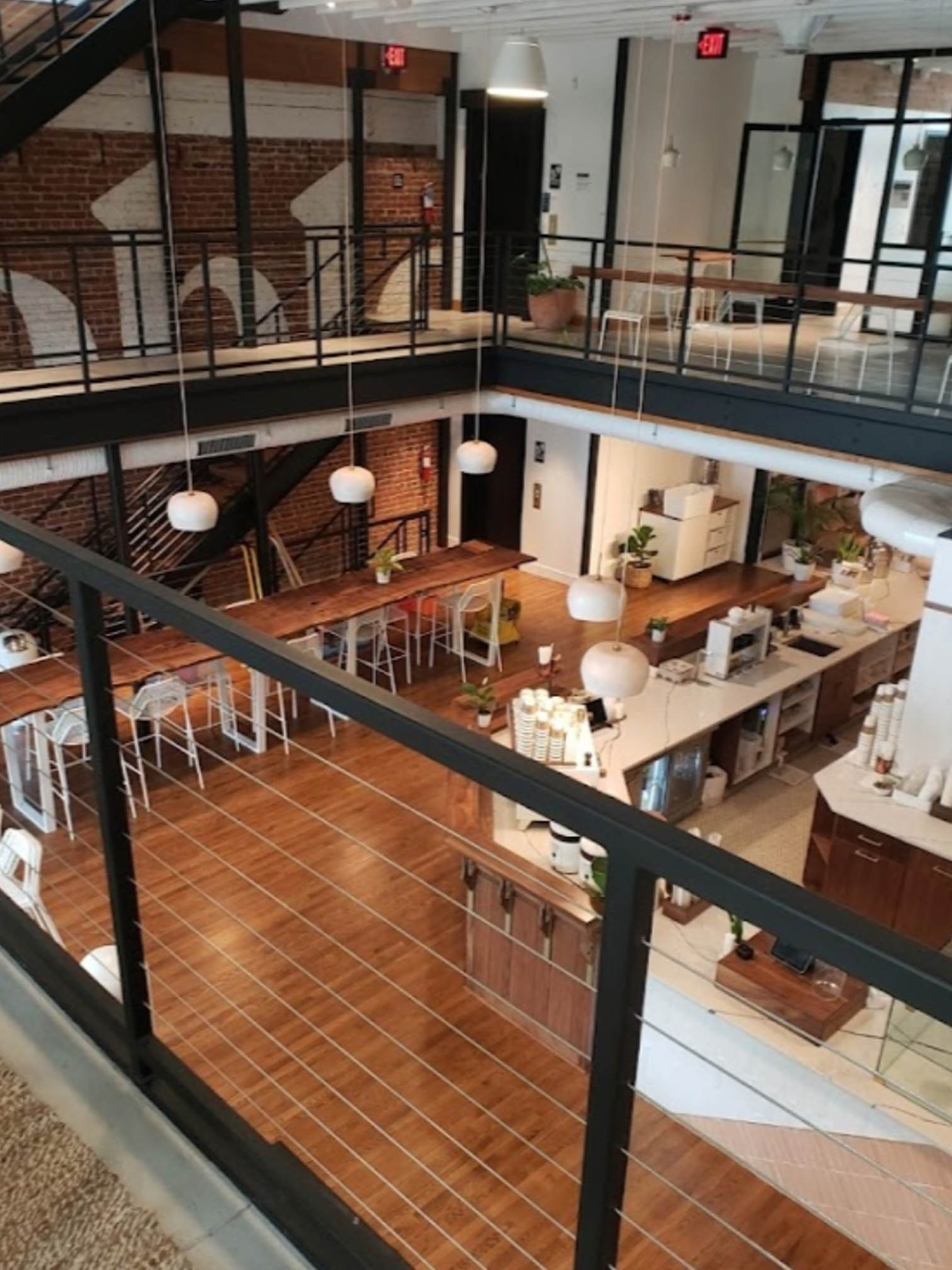 clean and modern café viewed from a balcony with well-arranged tables and chairs