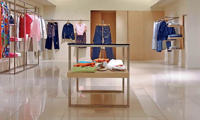 a clean and organized retail store with neatly arranged clothes